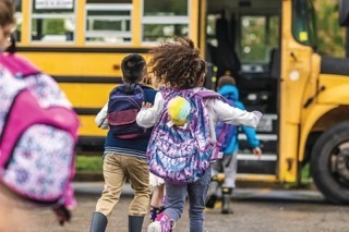 Students getting on a school bus